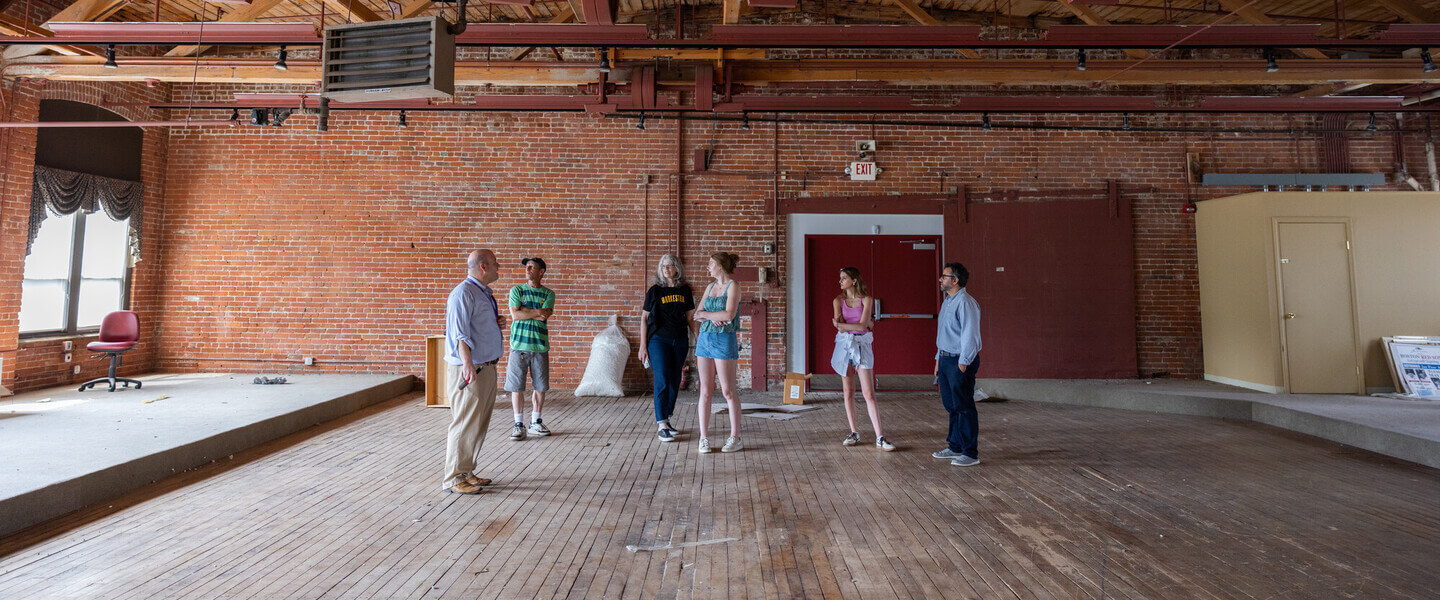 People standing in an old mill building