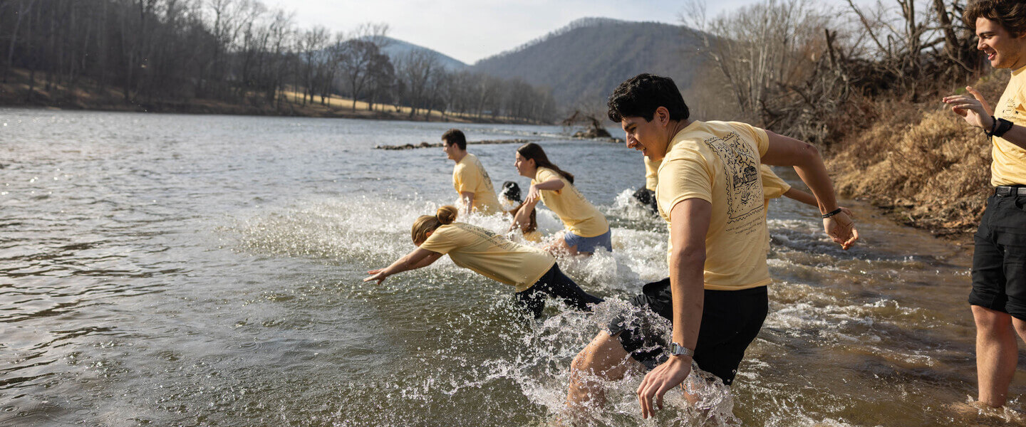 Students diving into a river