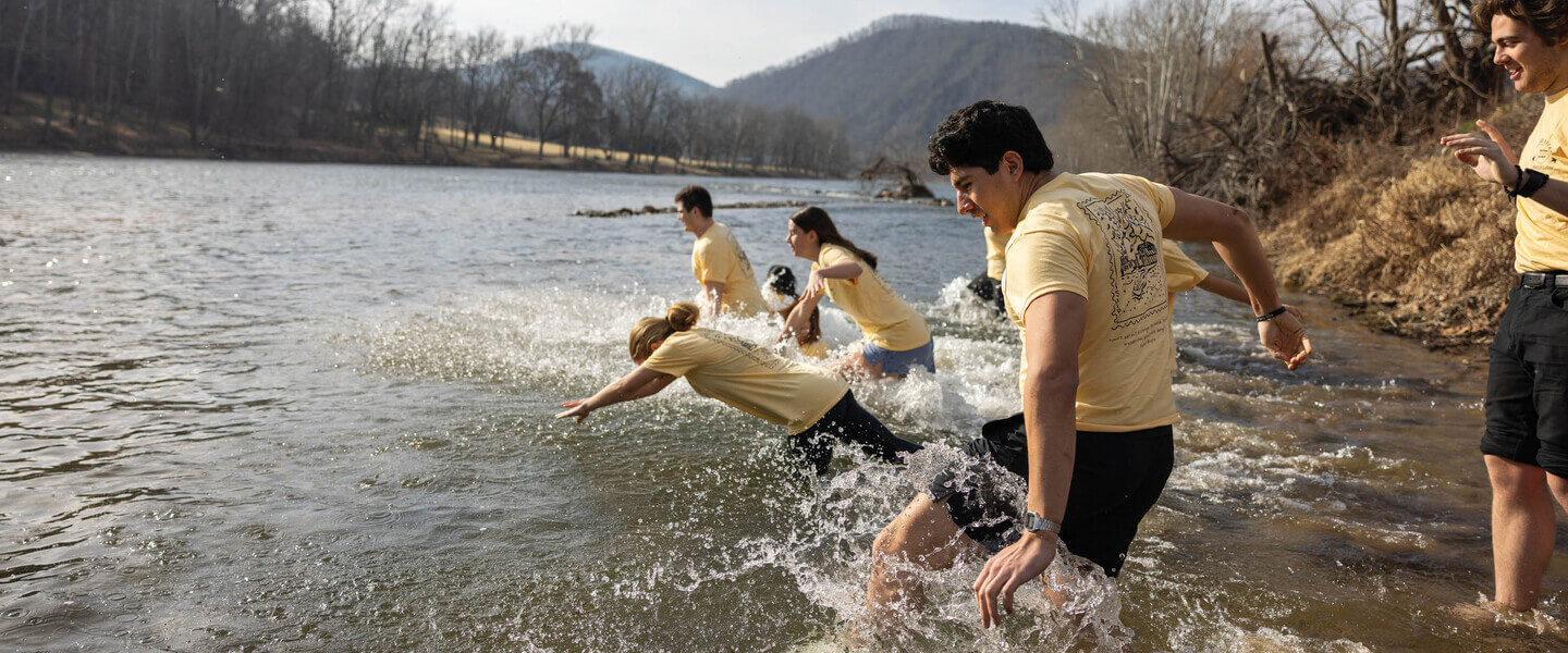 Students diving into a river