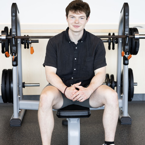 Man sit on weight bench