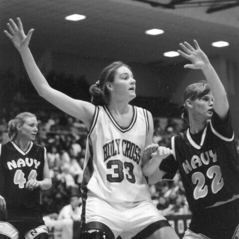 Woman basketball player dribbles against opponent