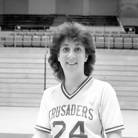 woman basketball player poses with ball