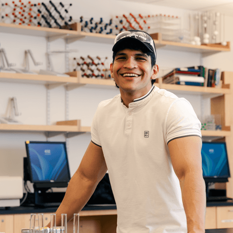 Hernandez standing in a lab classroom