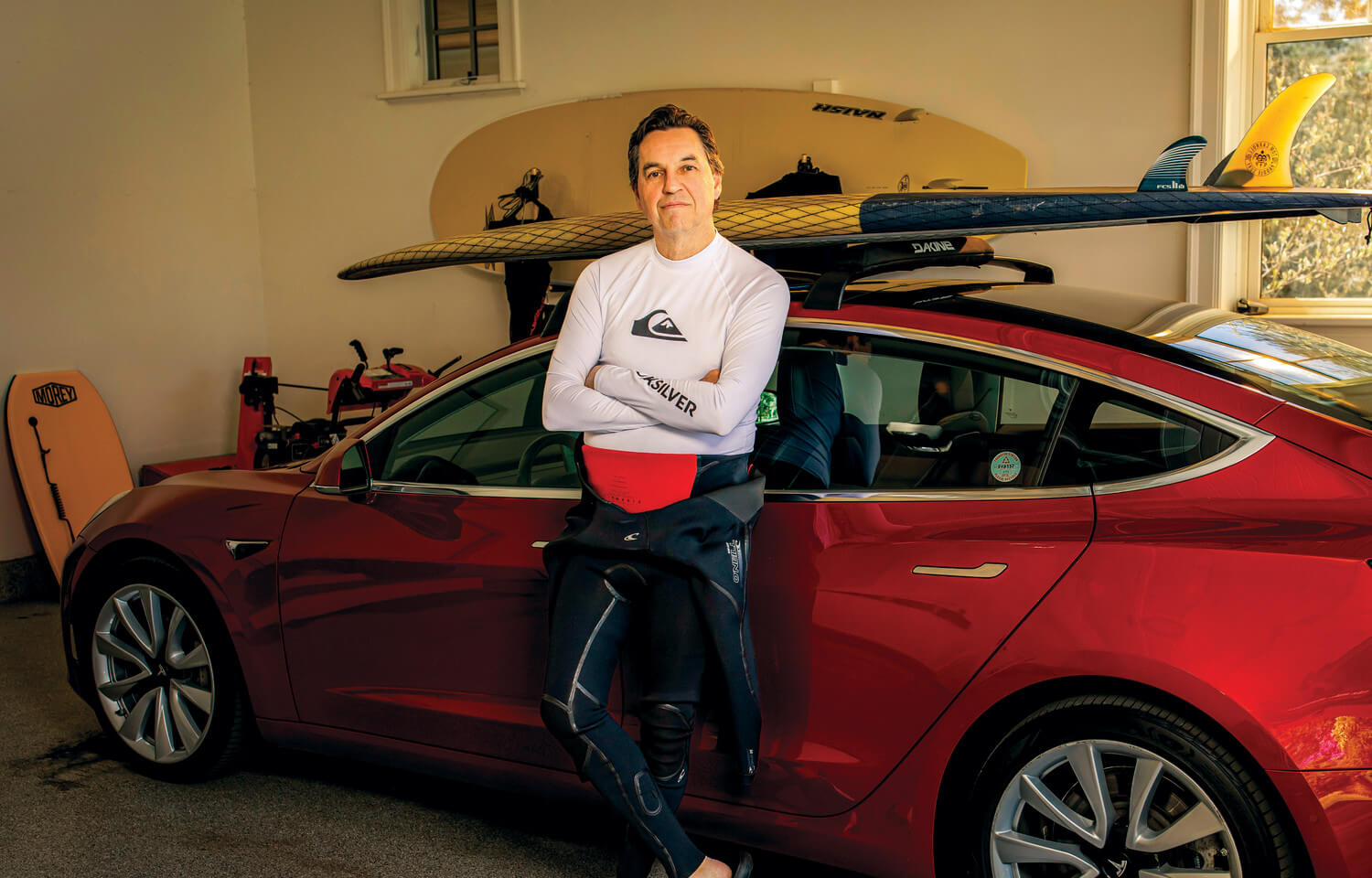 Man stands in front of a sports car