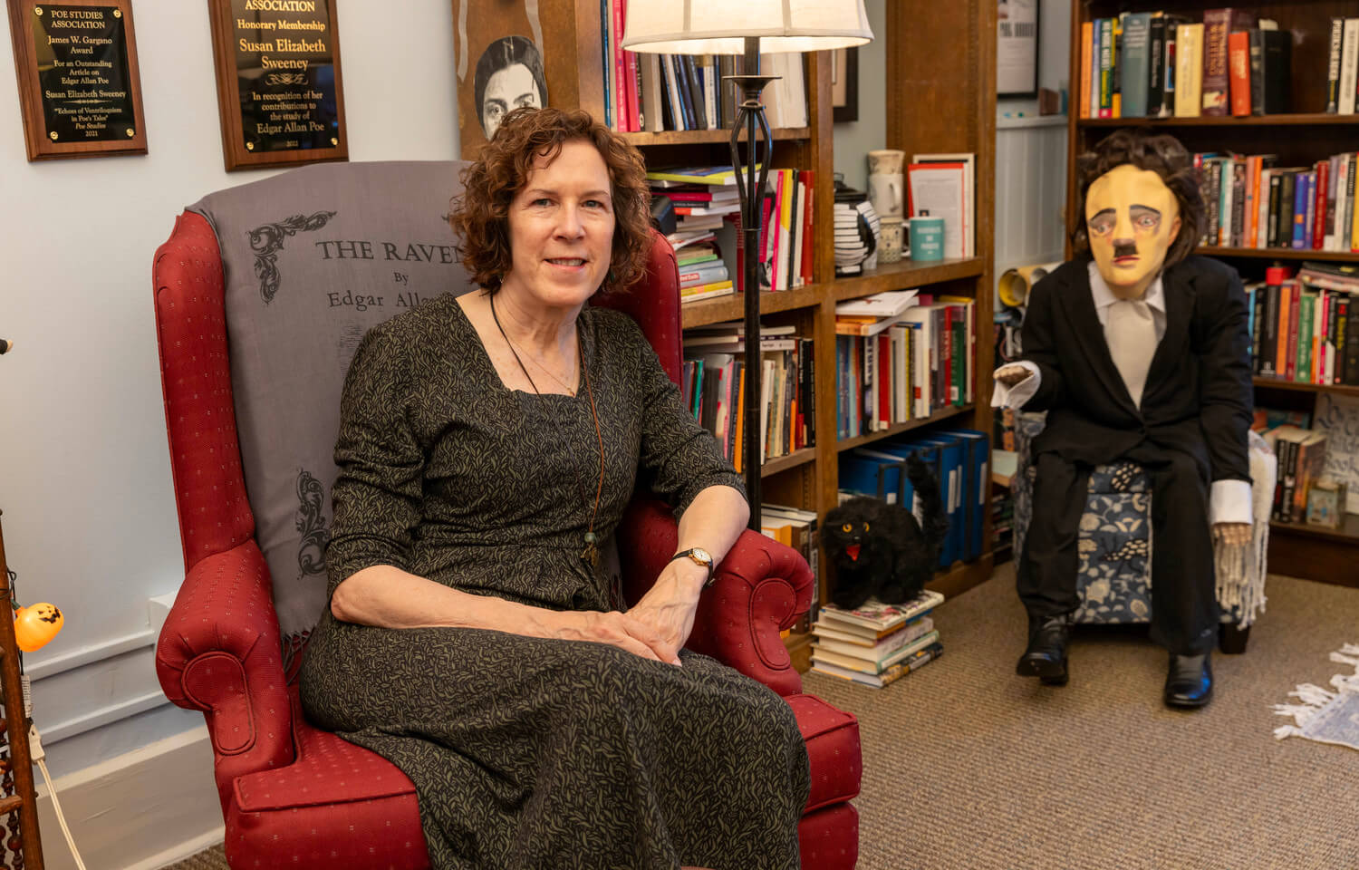 woman in office with Edgar Allan Poe doll
