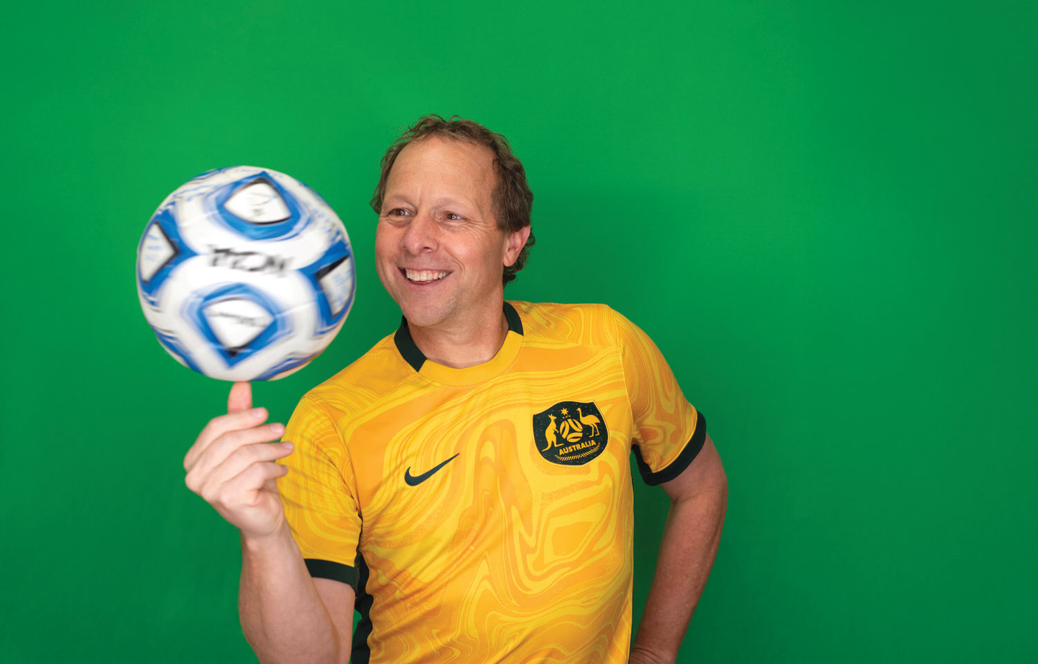 Man spins soccer ball on hand