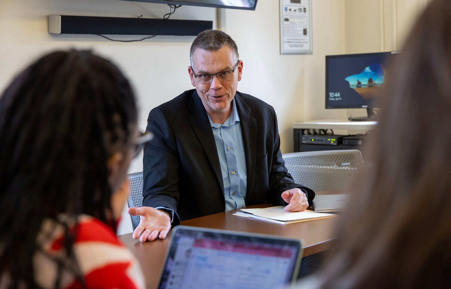 Man talking with students