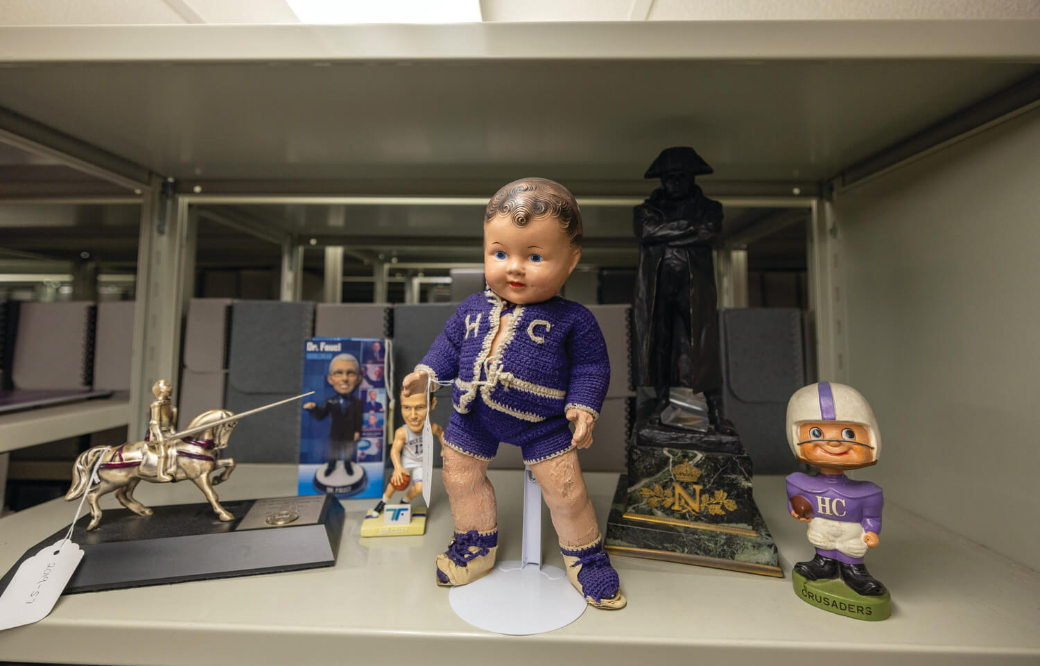 Holy Cross baby doll surrounded by other artifacts