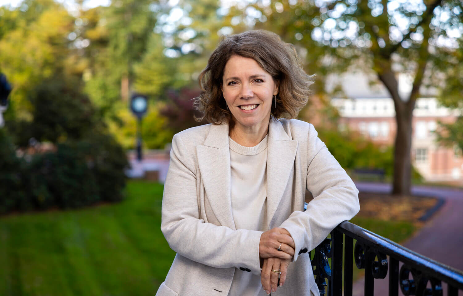 Woman leaning against wrought-iron railing