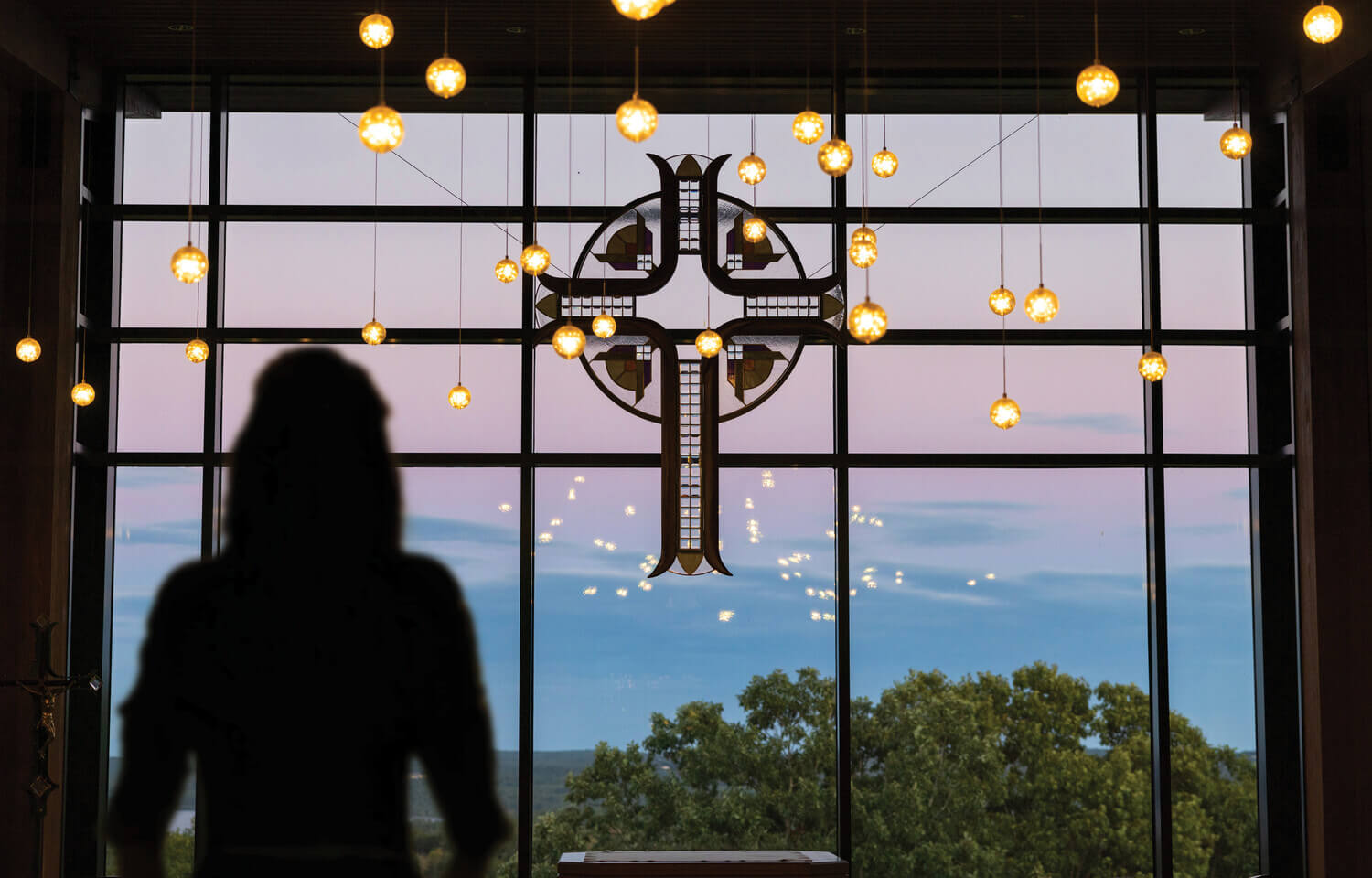 Silhouette of a person in front of the window at the Joyce Contemplative Center