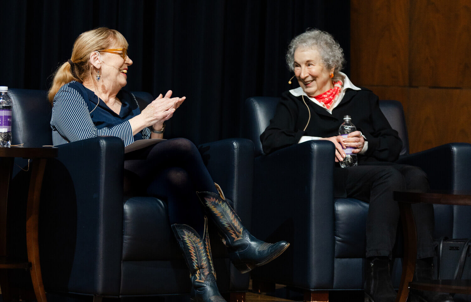 Two women sit in chairs talking