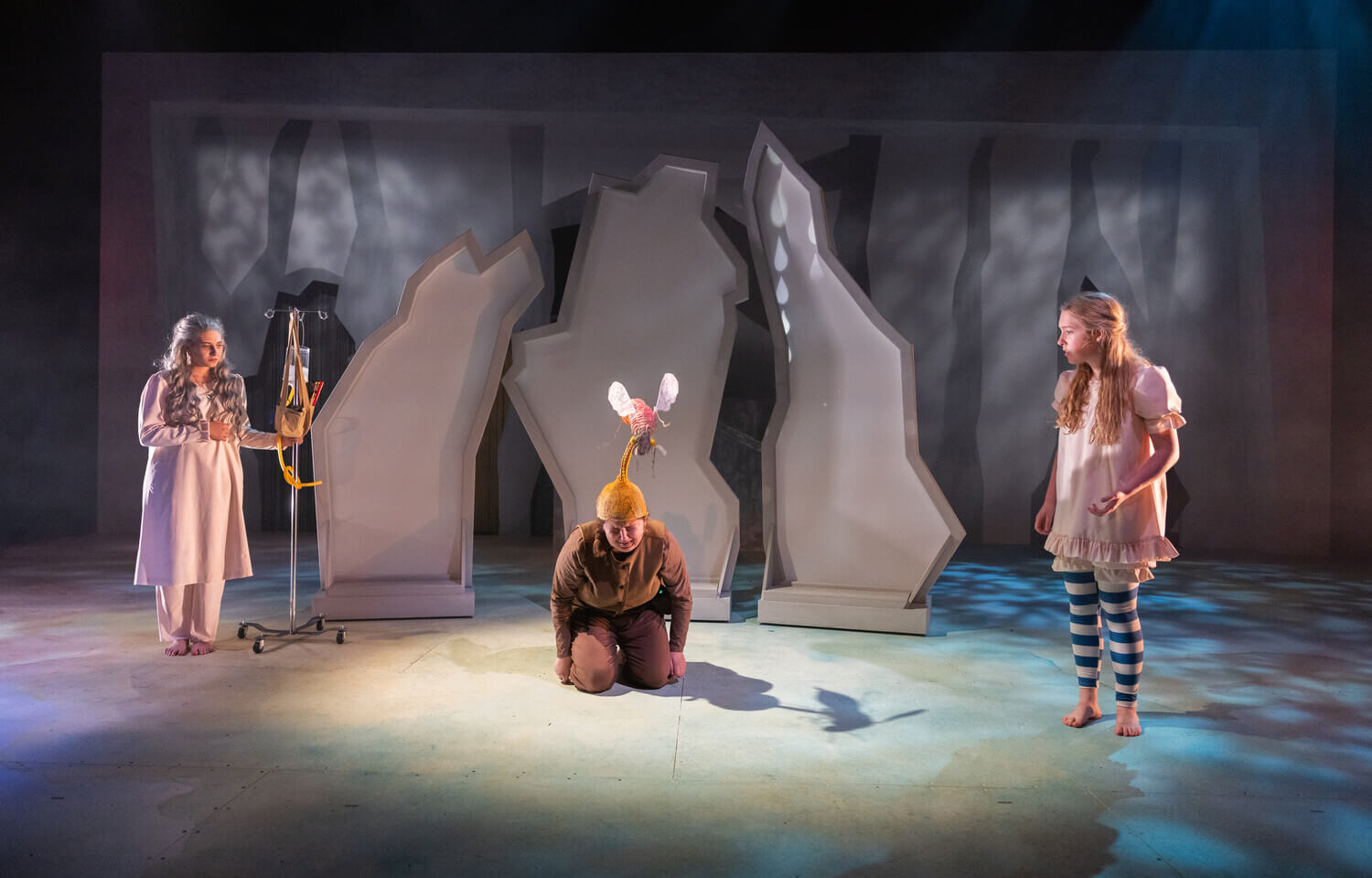 Three students on a stage