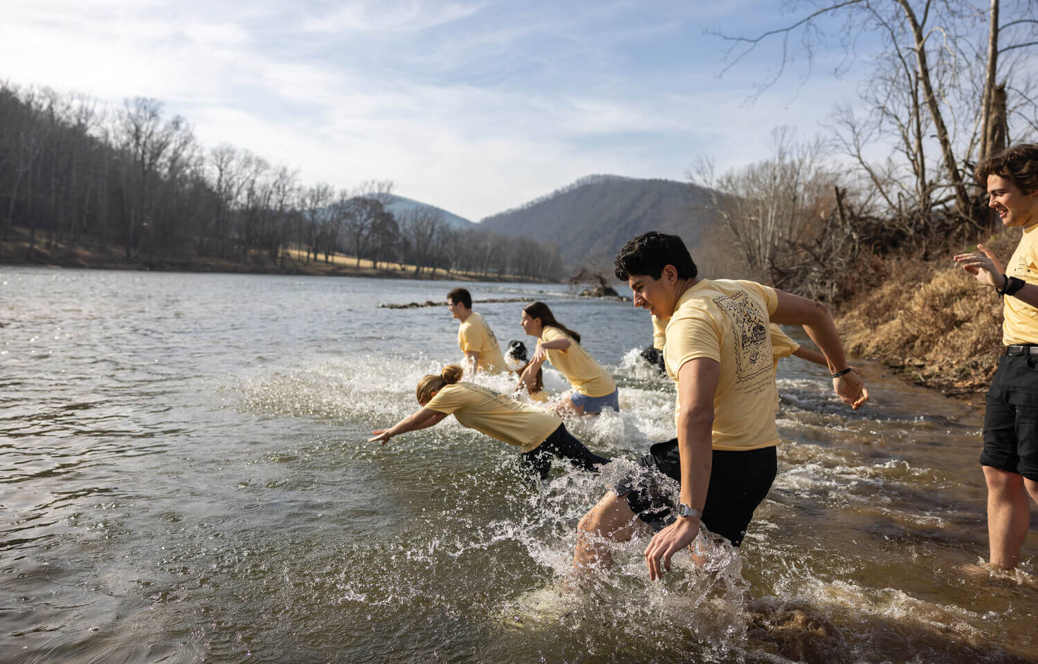 Students diving into a river