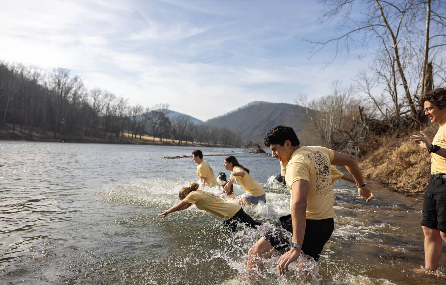 Students diving into a river