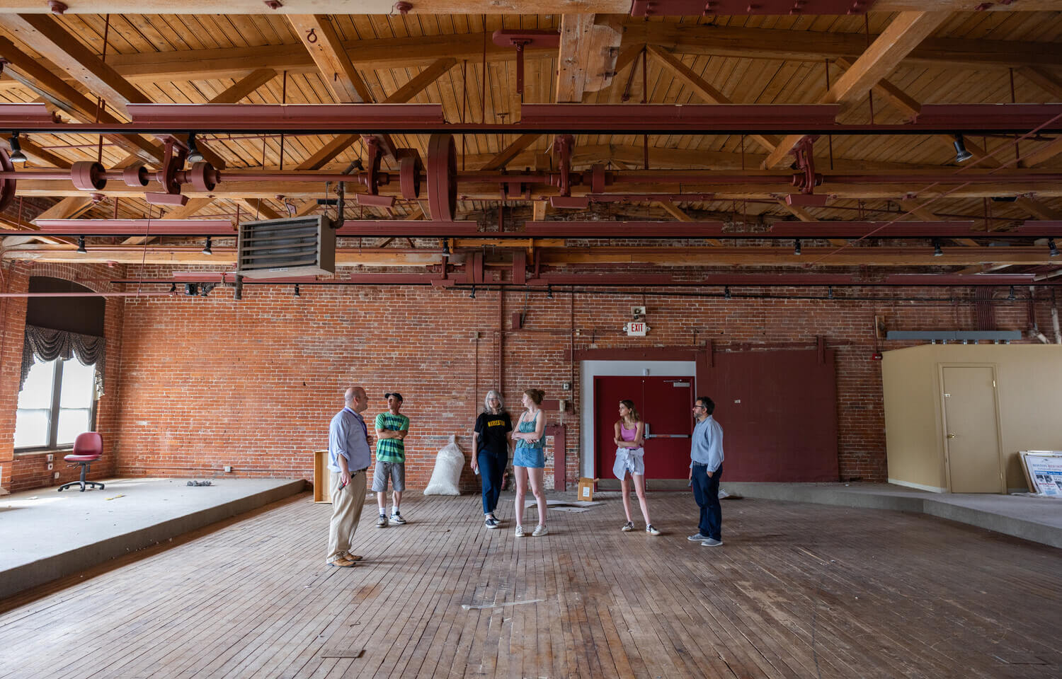 People standing in an old mill building
