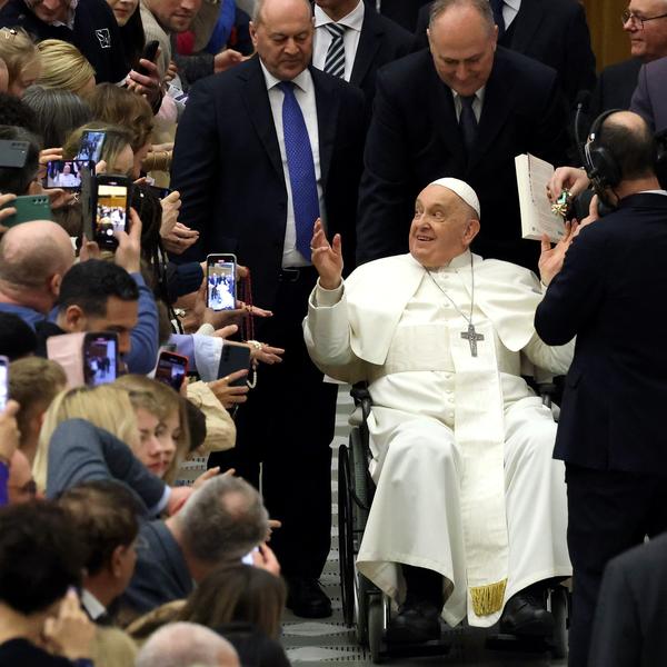 Pope Francis waves to the faithful.