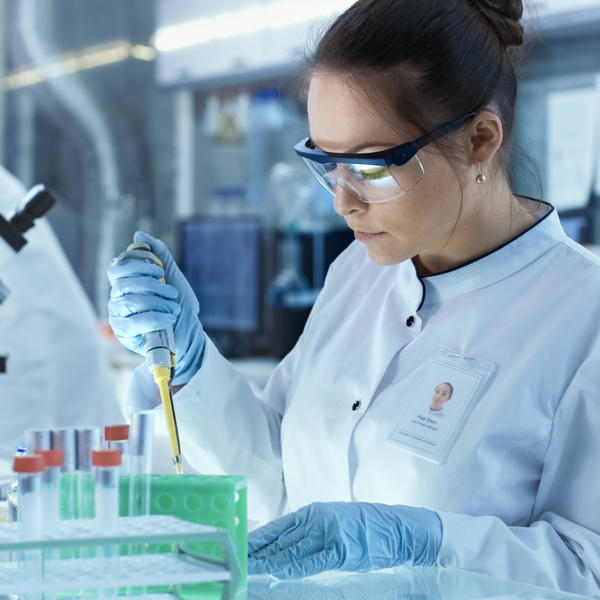 Two women in labcoats work in a lab
