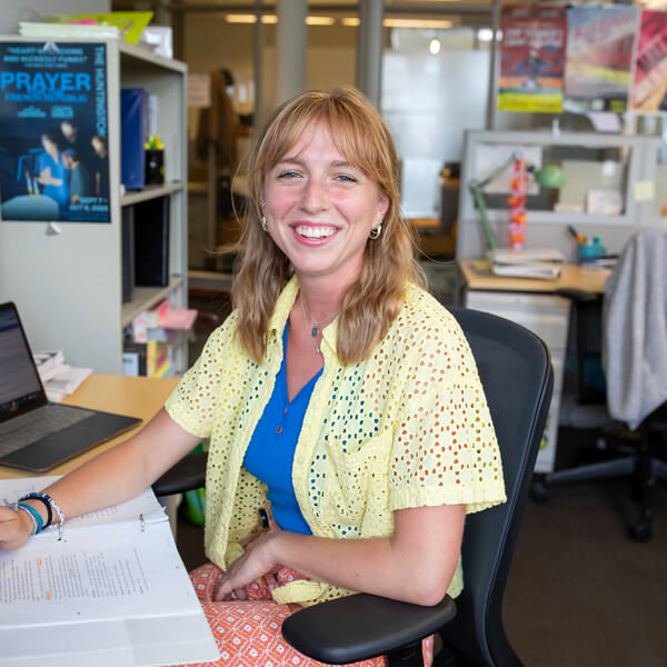 Woman sits at desk