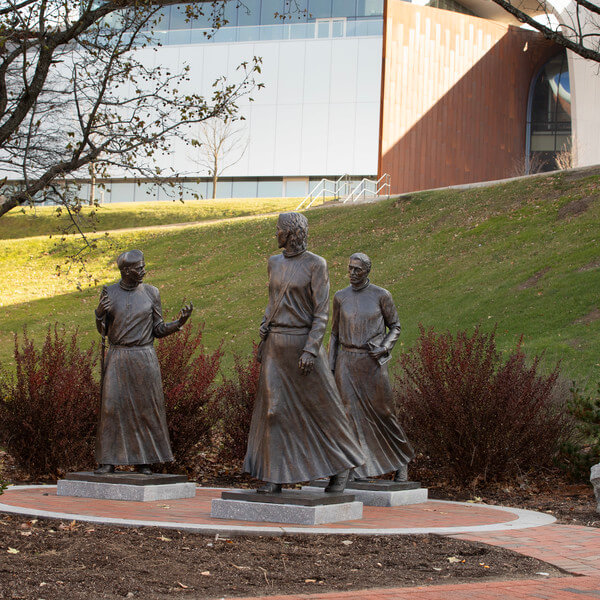 A statue featuring three men walking together