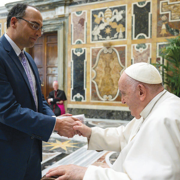 two men shake hands