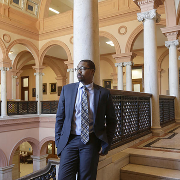 Che Anderson '11, project manager with the City of Worcester stands at Worcester City Hall. Photo by Tom Rettig