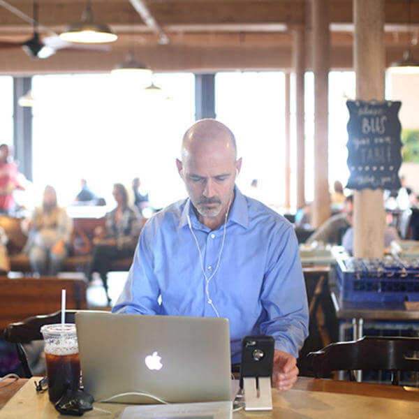 Ed O'Donnell, associate professor of history at Holy Cross, is seen here working on his podcast "In The Past Lane" at BirchTree Bread Company in Worcester. Photo by Tom Rettig