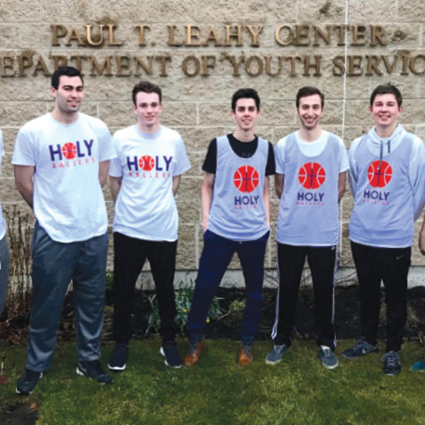 Riley Benner ’20 (center) and some of the “Holy Ballers” SPUD volunteers outside the Leahy Center in Worcester.