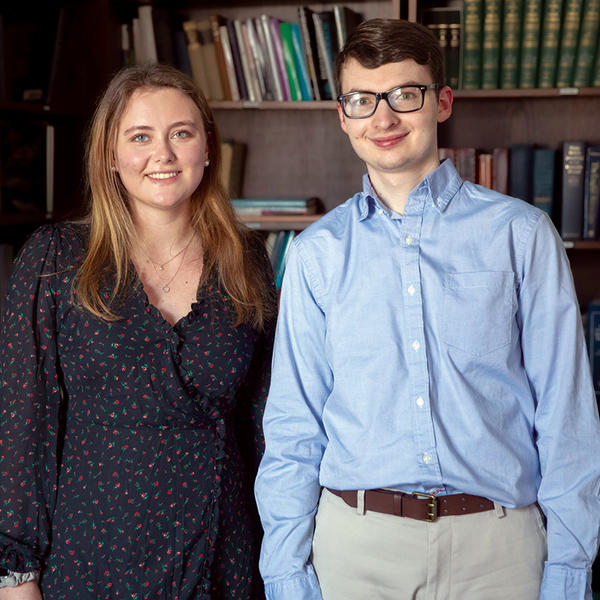 Two students, a woman and man posing for a picture