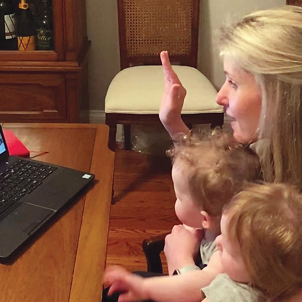 Alicia Molt-West takes her oath of office virtually, with her twin daughters seated on her lap.