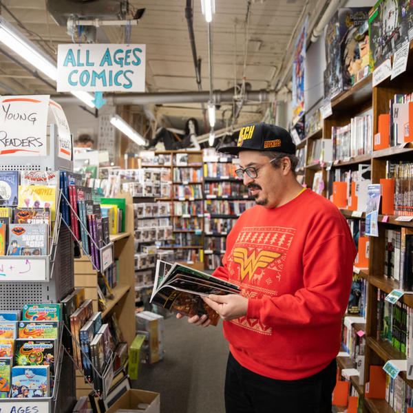 Jorge Santos, associate professor of English, browsing through the comic books at That's Entertainment in Worcester. Photo by Avanell Chang