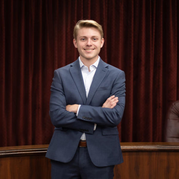 Male student dressed in suit.