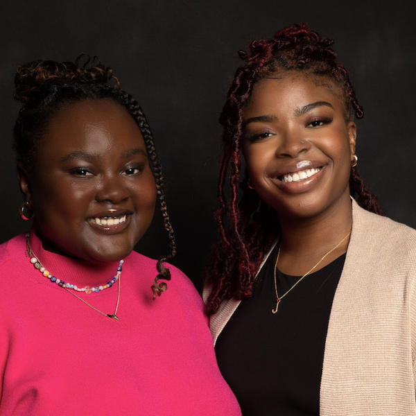 Two women smile for a portrait