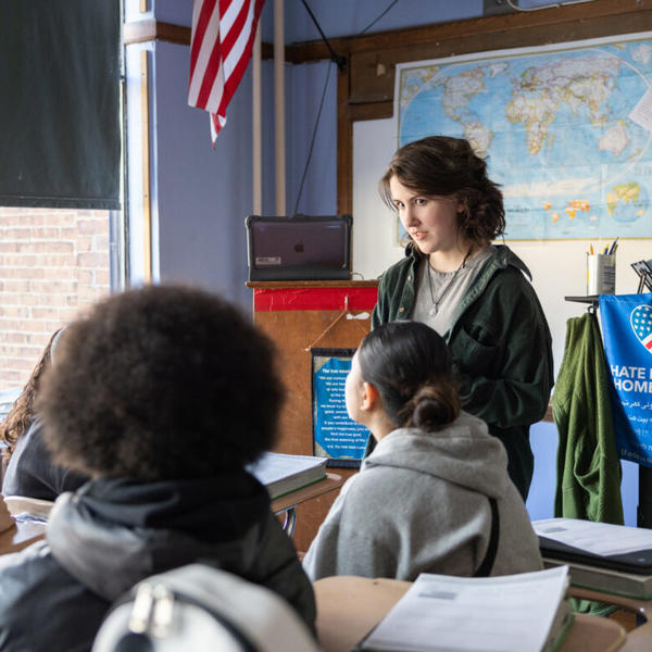 A young woman teaches a classroom of students in Worcester, MA.