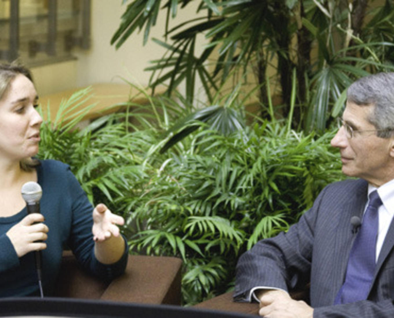 Woman sitting next to Dr. Anthony Fauci