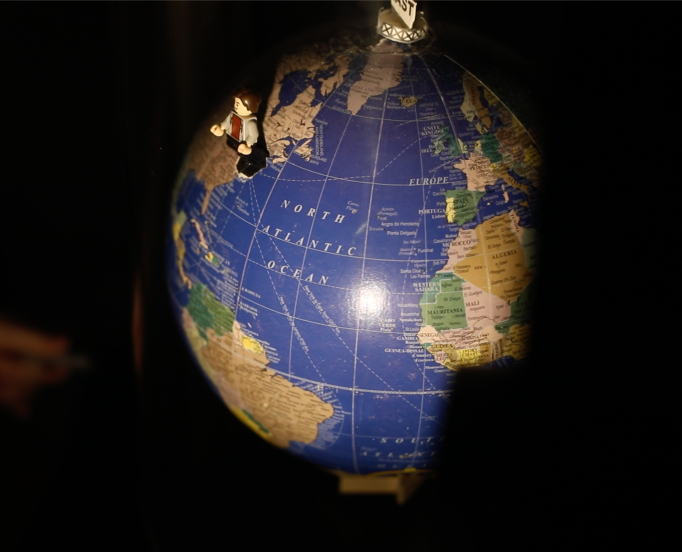 A closeup of a globe with a spotlight pointed on it.