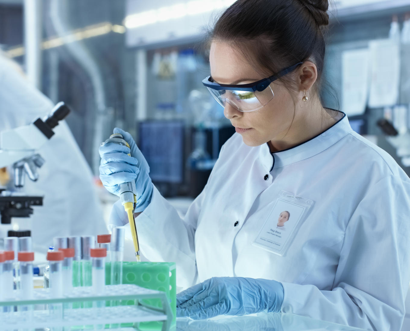 Two women in labcoats work in a lab