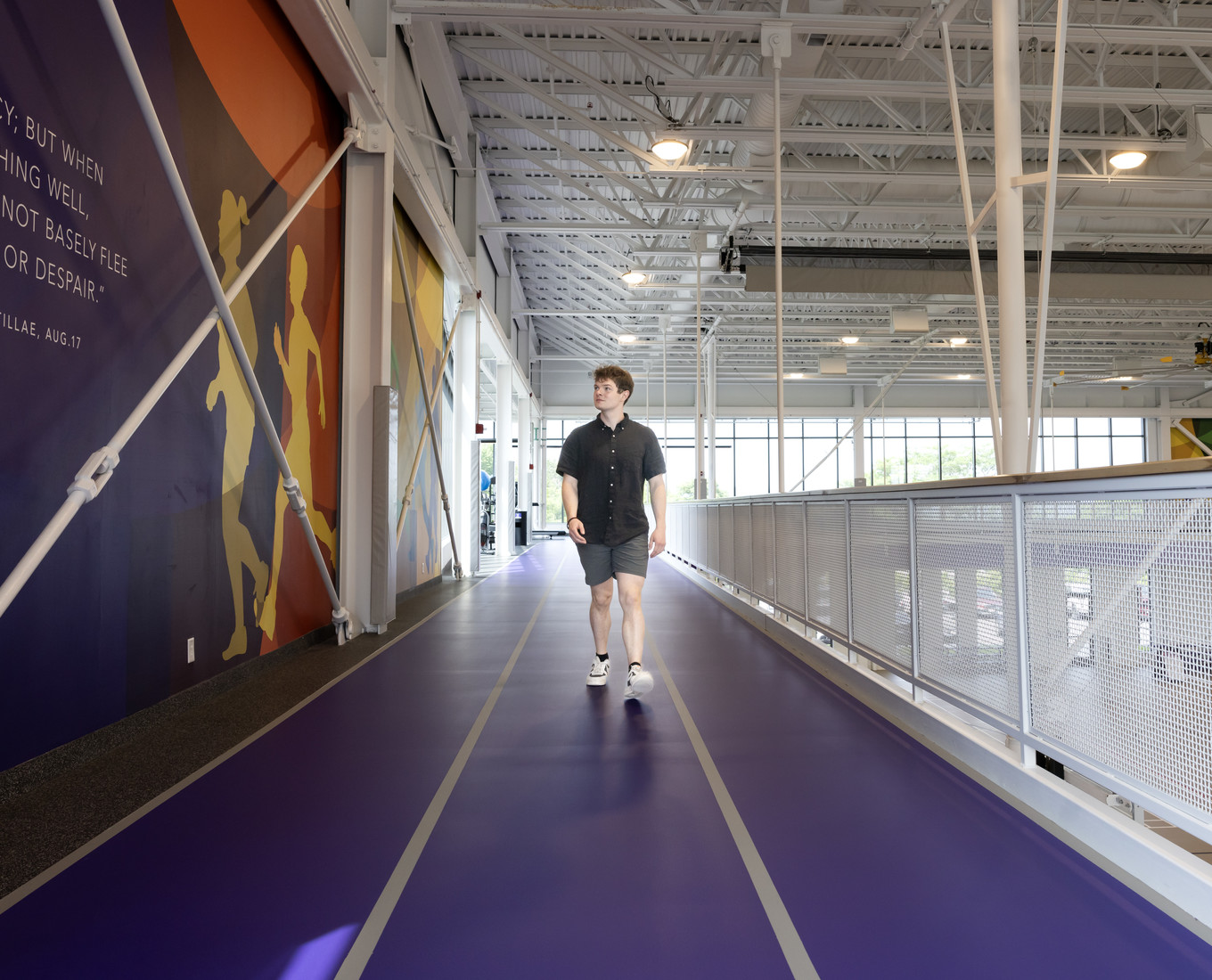 Man walks on indoor track