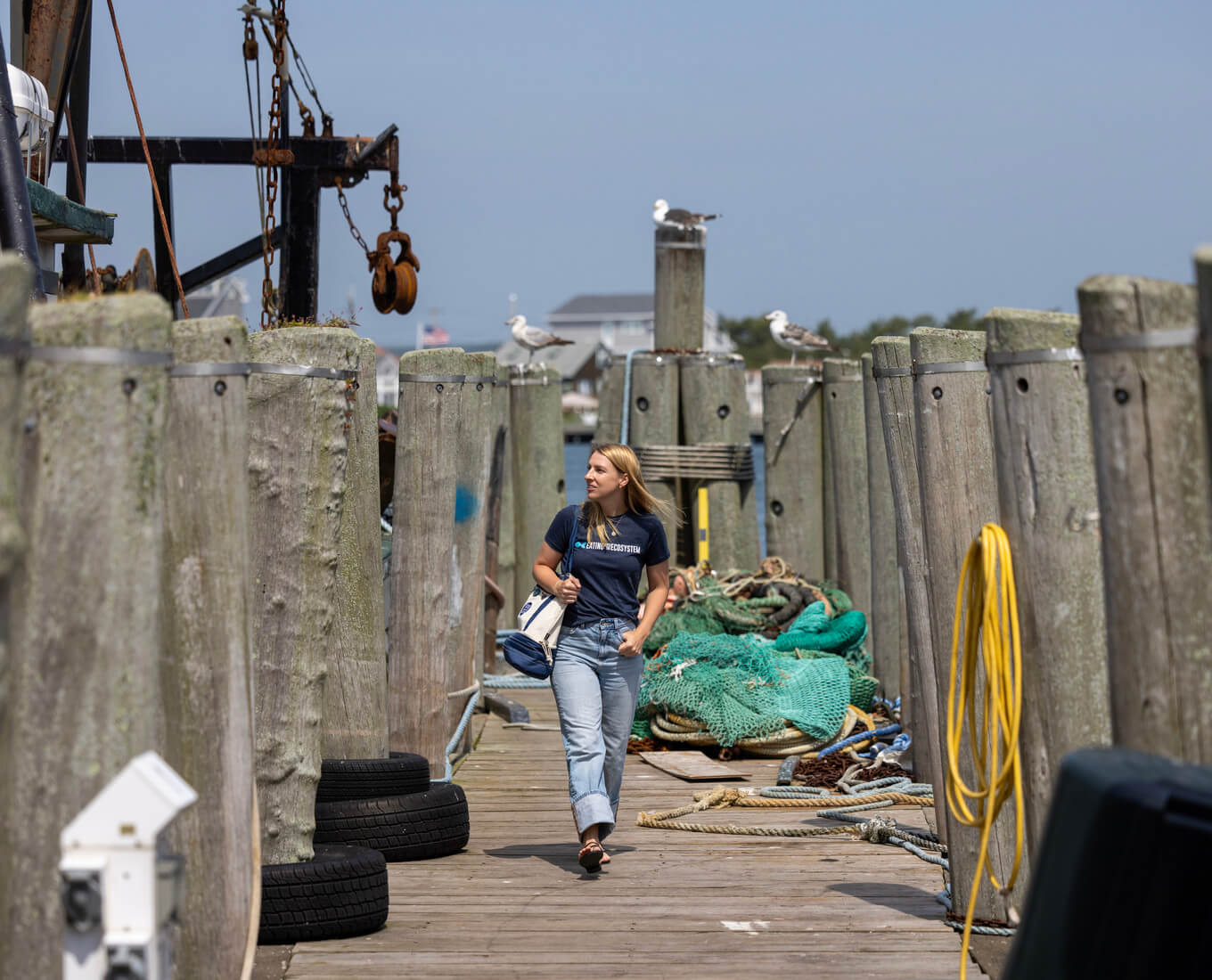 Woman walks toward camera on a dock