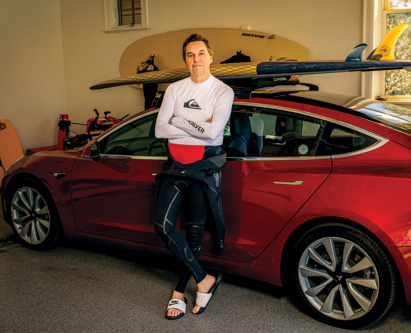 Man stands in front of a sports car