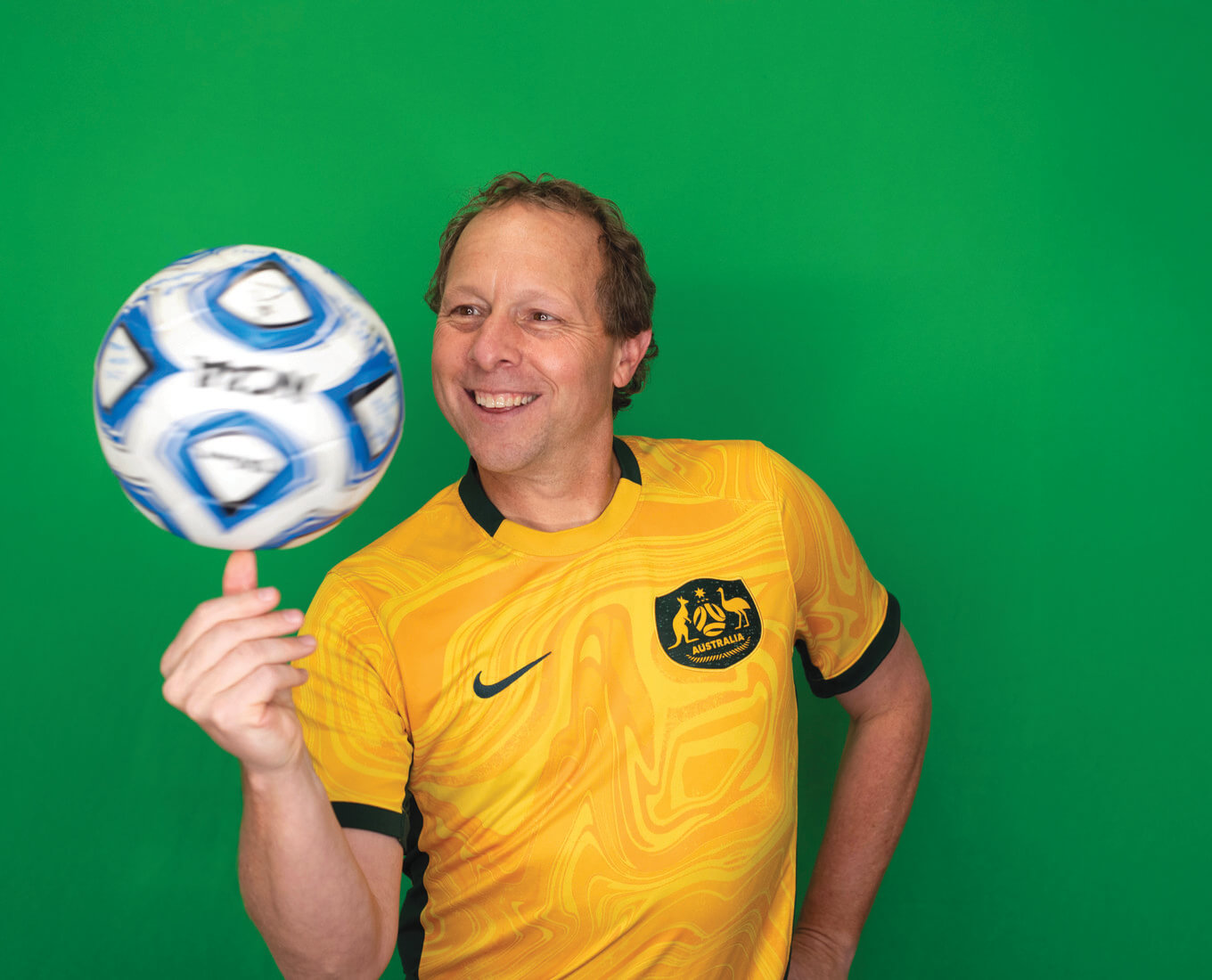 Man spins soccer ball on hand