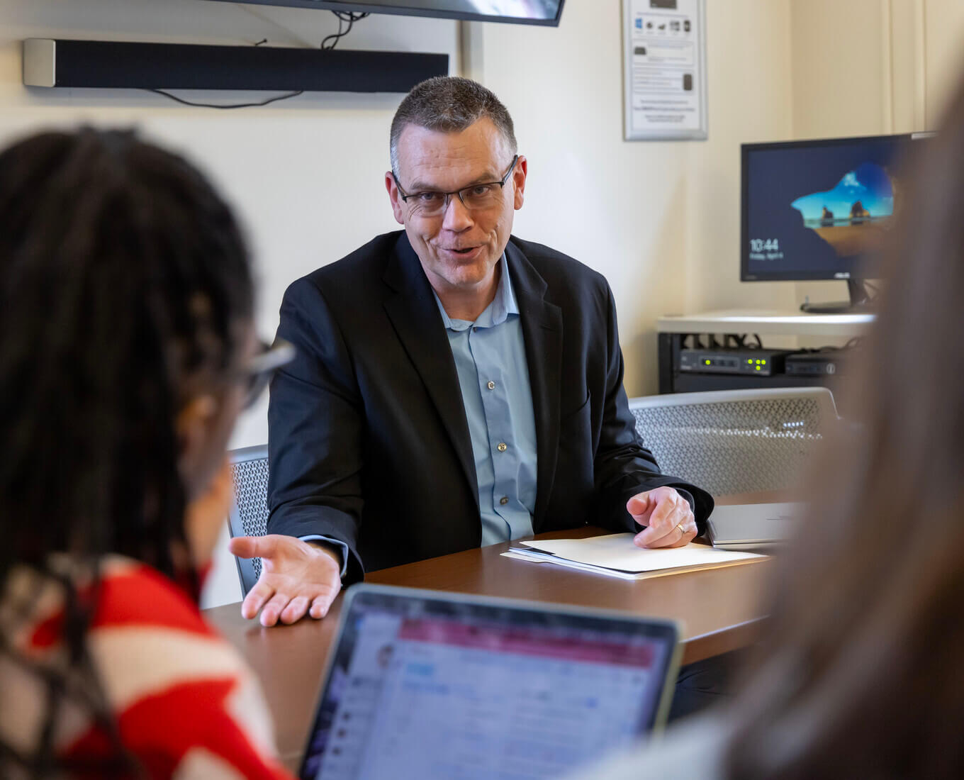 Man talking with students