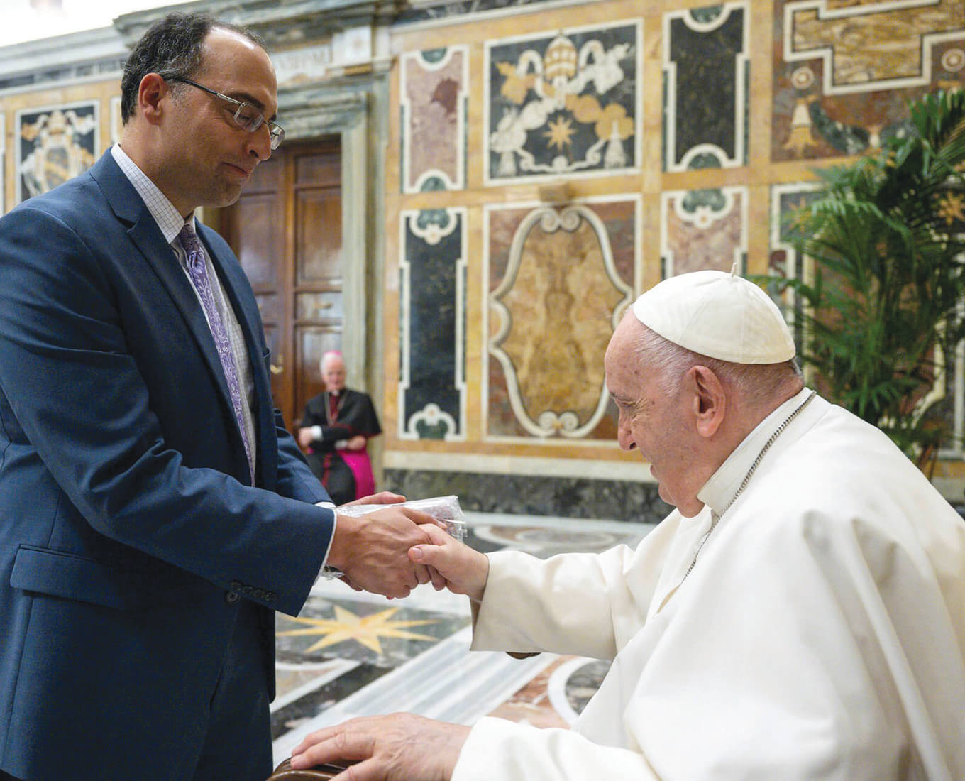 two men shake hands