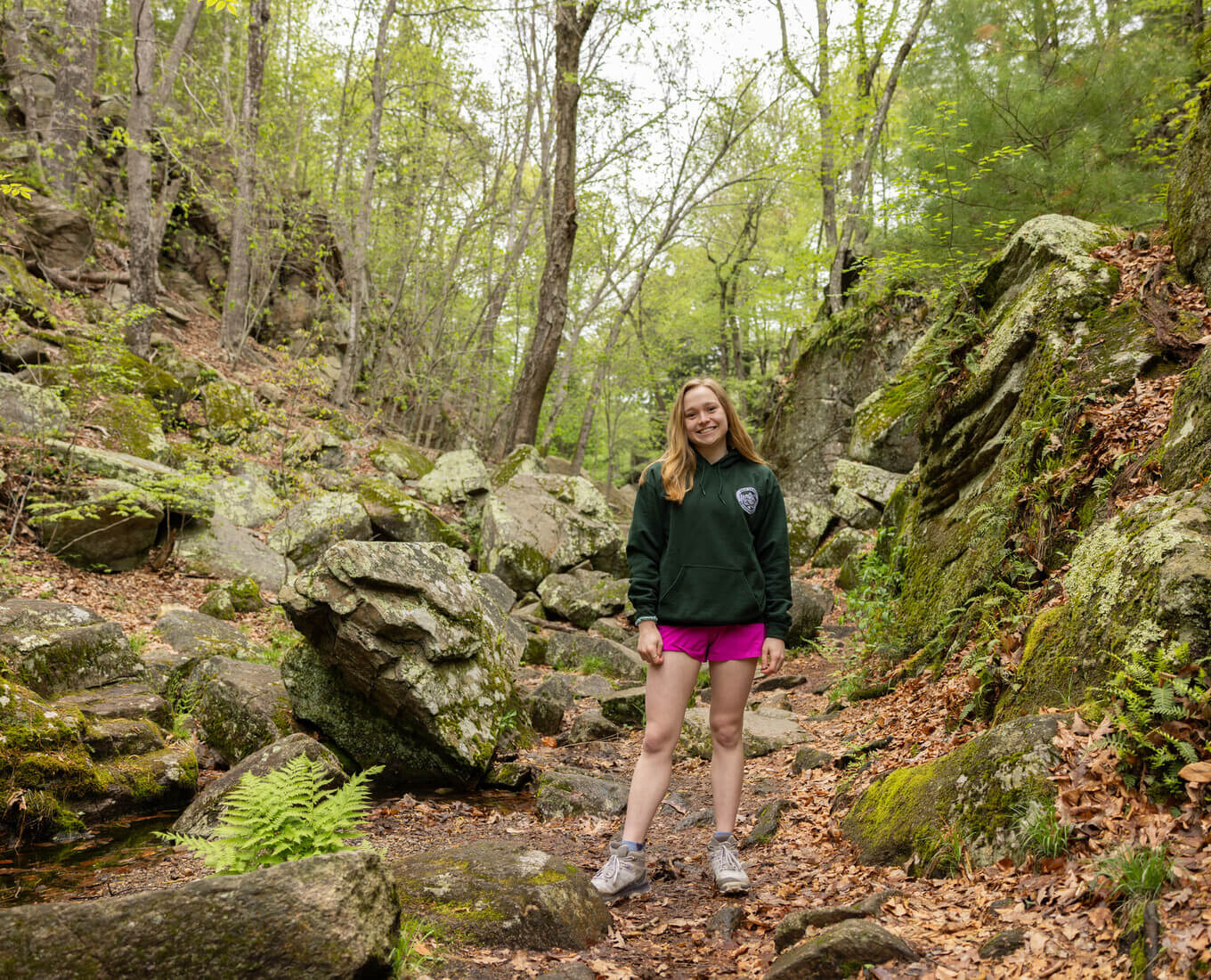 Student standing on a trail at Purgatory Chasm