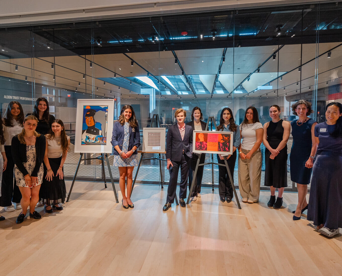 Holy Cross college students stand aside art work