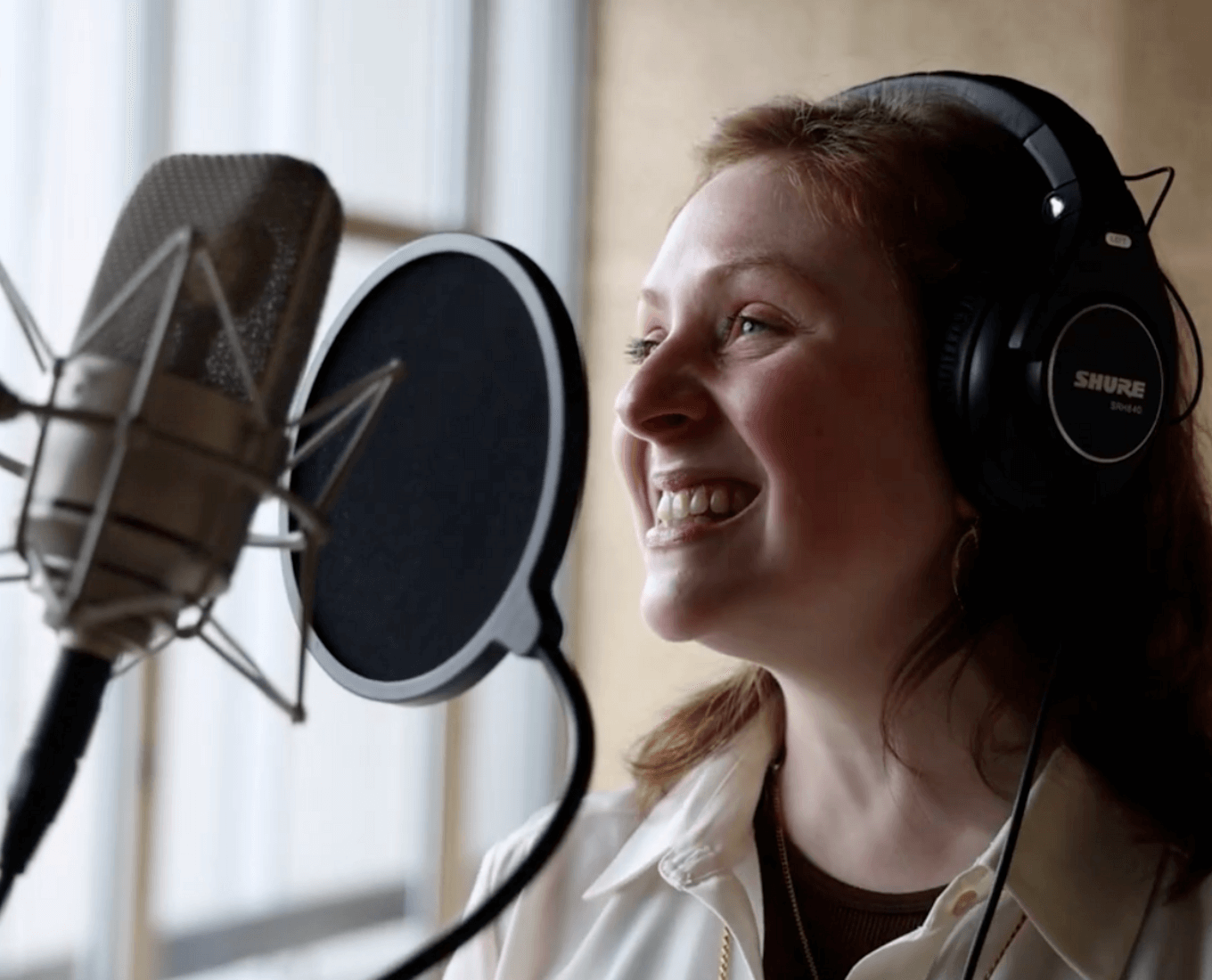 Woman sings at microphone