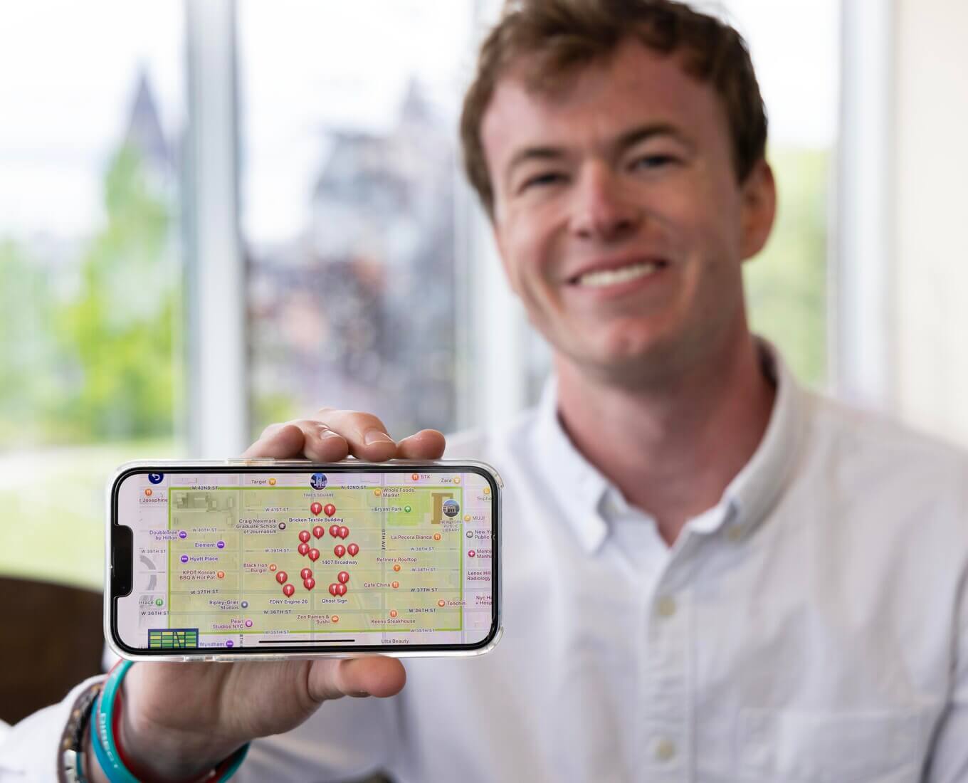 Thomas Creighton '25 holding a phone