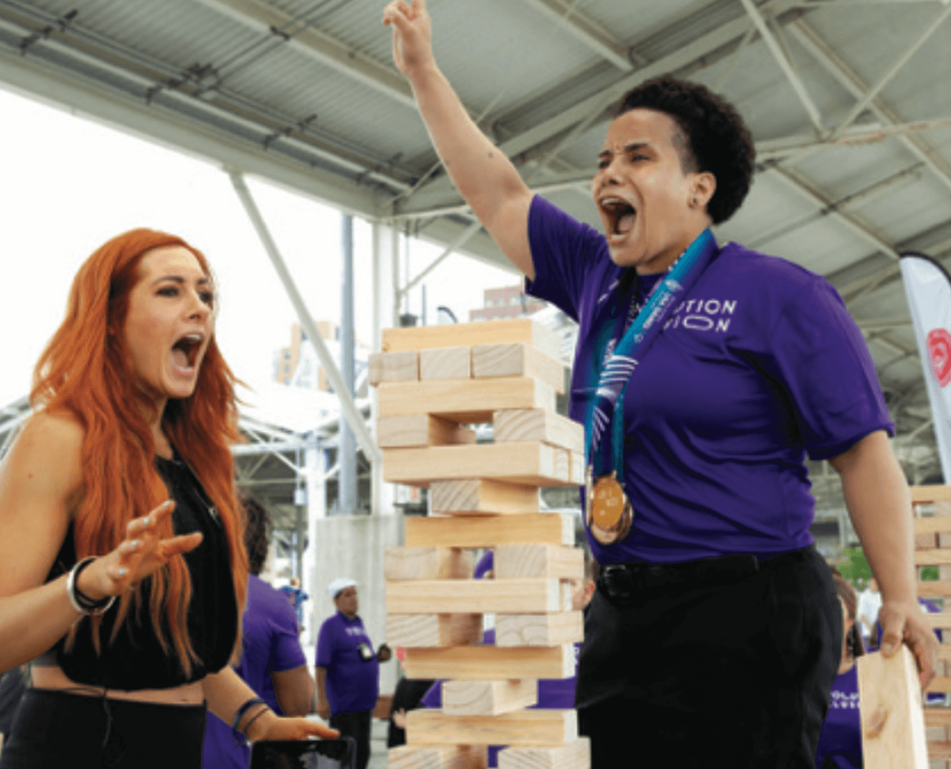 two women play jenga
