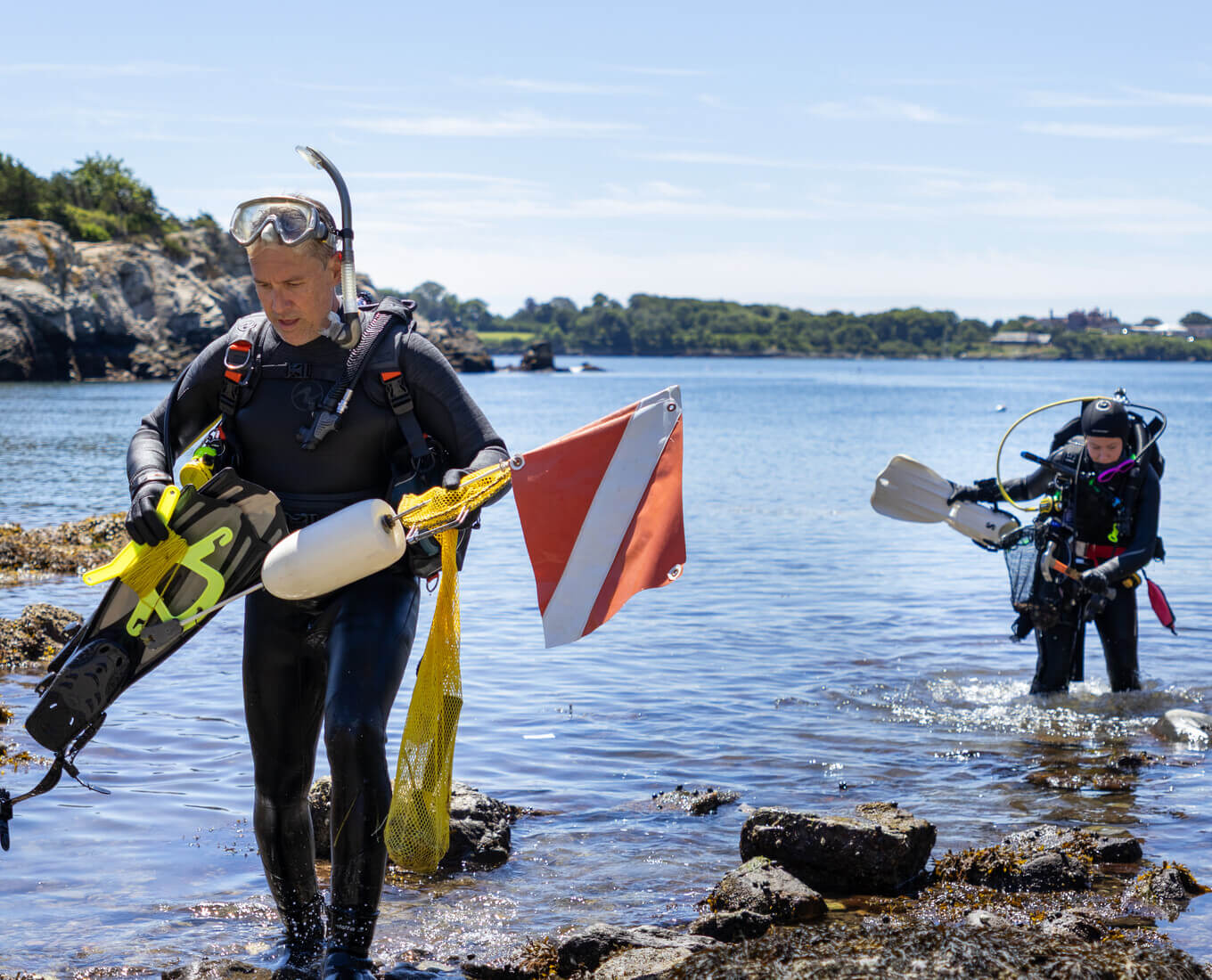 Two scuba divers returning from the water