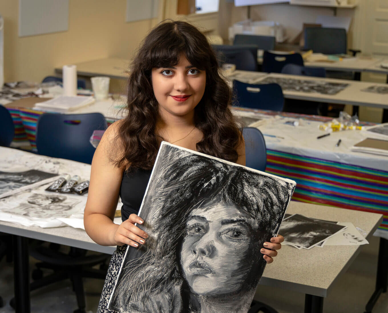 Sophie Sundaram '26 holding a portrait