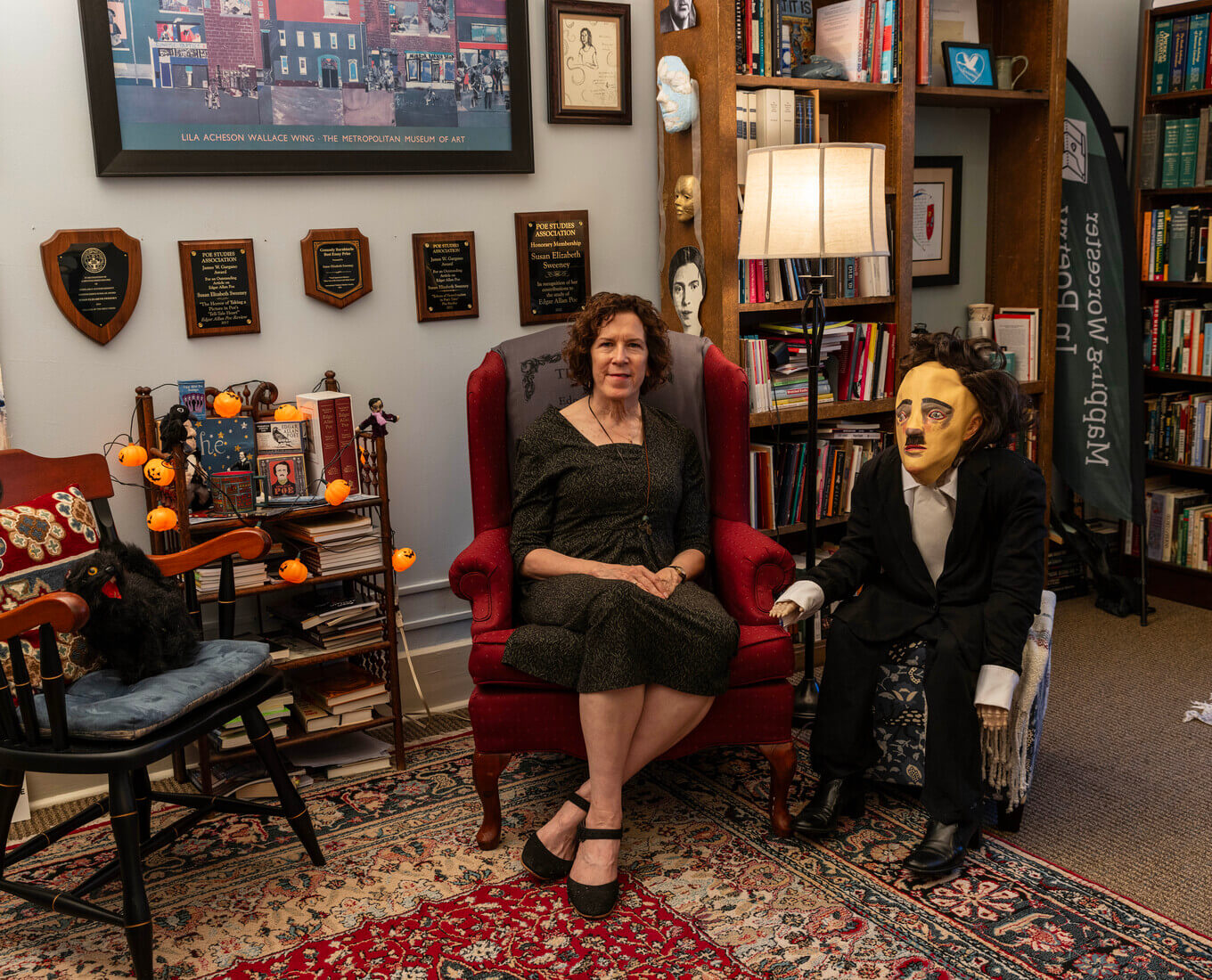 Woman, seated, with Edgar Allan Poe doll